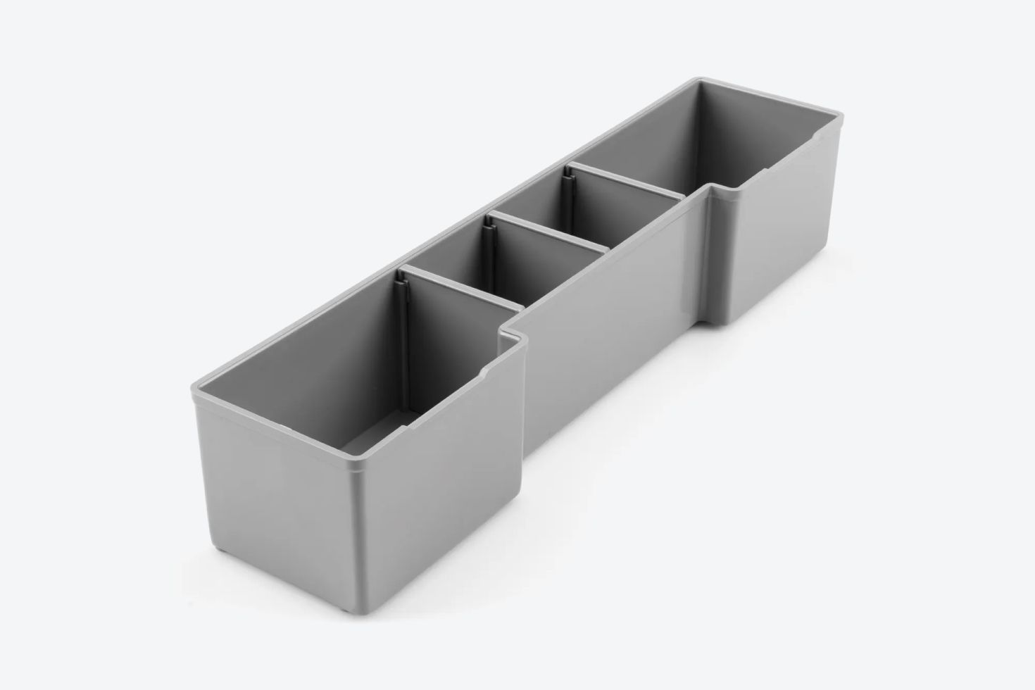 A gray organizer bin with dividers on a light gray background