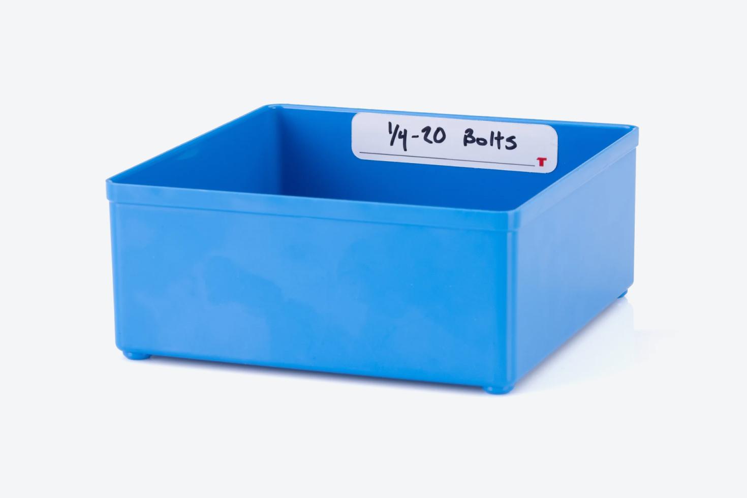 A blue organizer bin with a label that has "1/4 20 Bolts" hand-written on it.