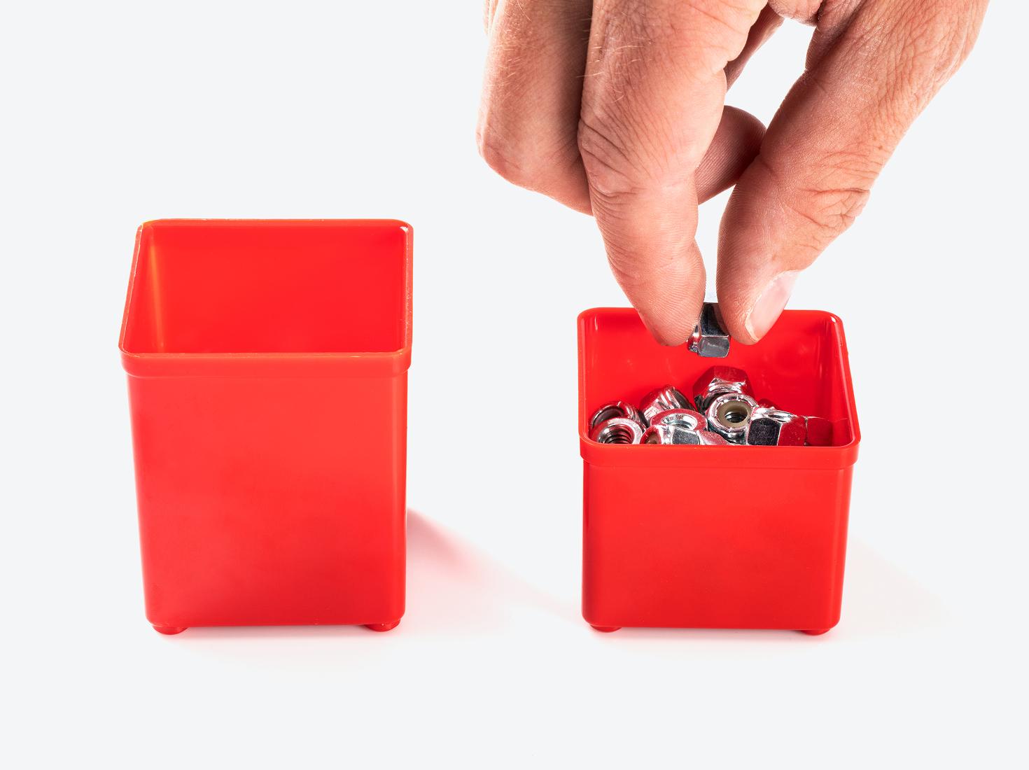 A red standard height organizer bin next to a red shallow bin.