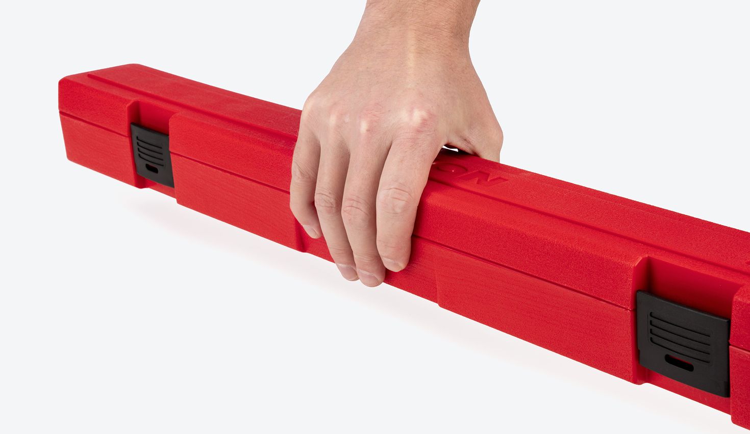 Hand holding a red torque wrench case.
