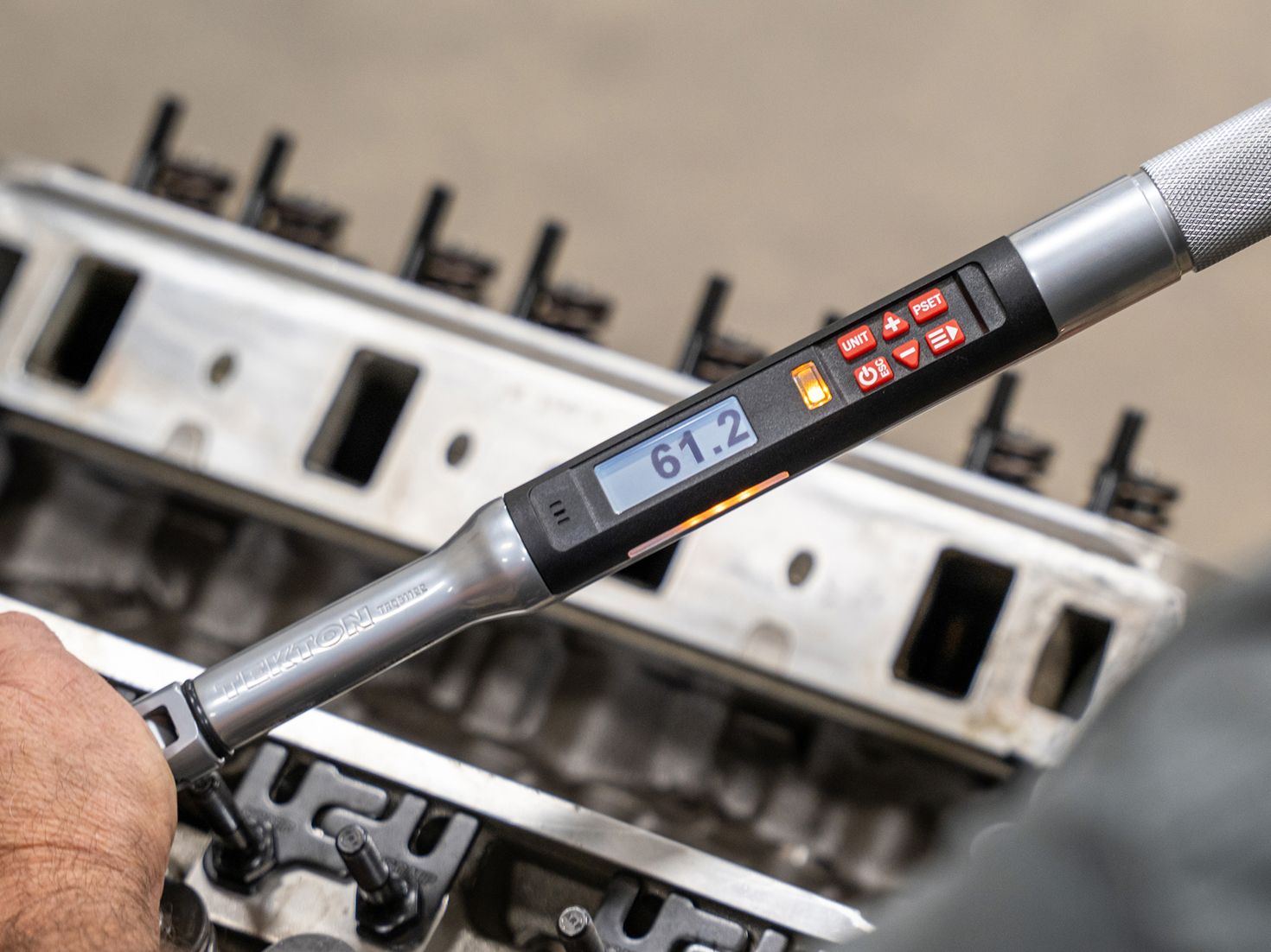 An electronic torque wrench being used with the screen facing the camera.
