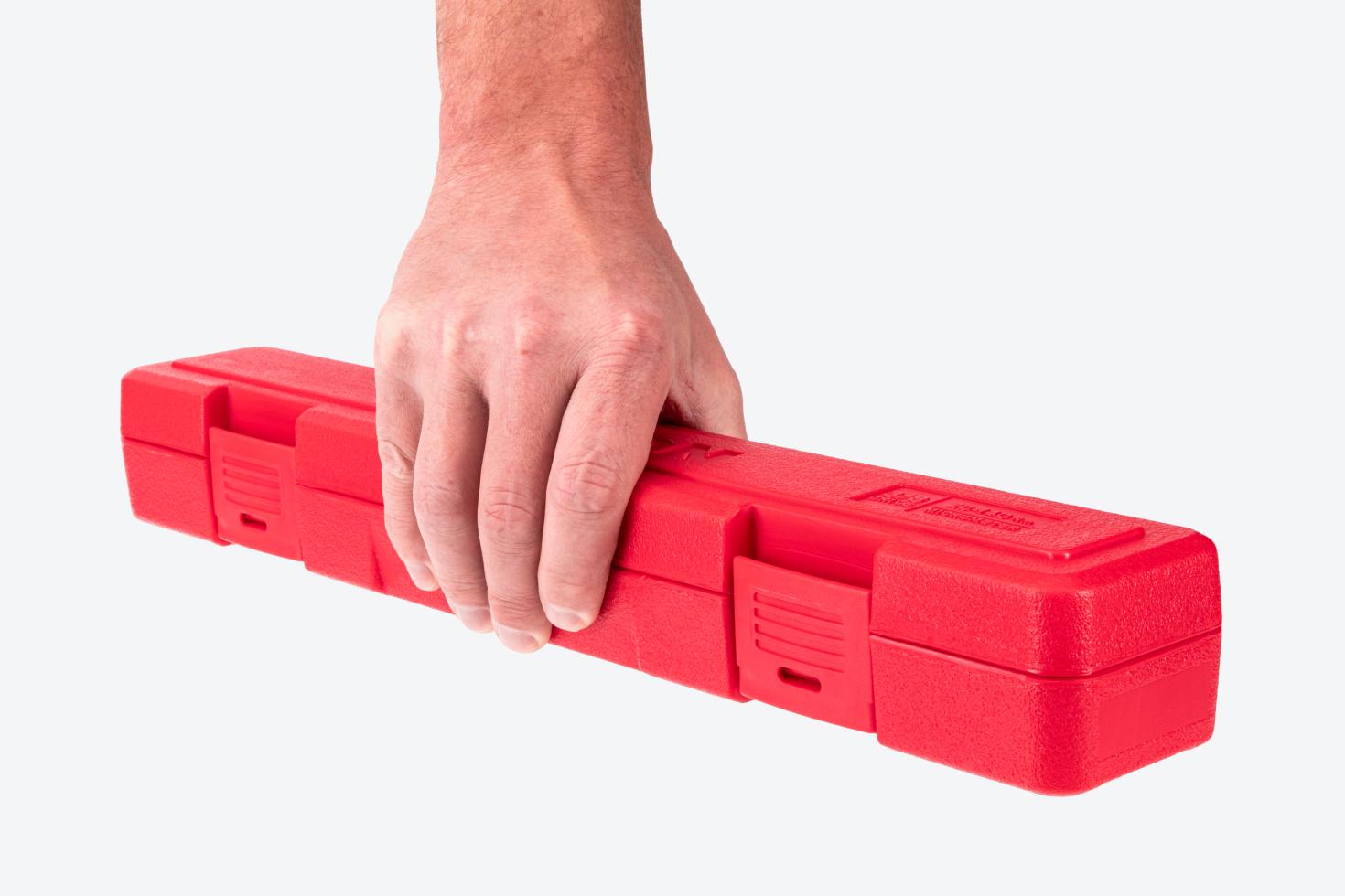 Hand holding a red torque wrench case.
