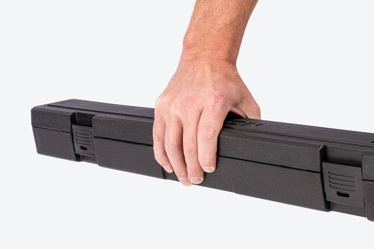 Hand holding a black torque wrench case.