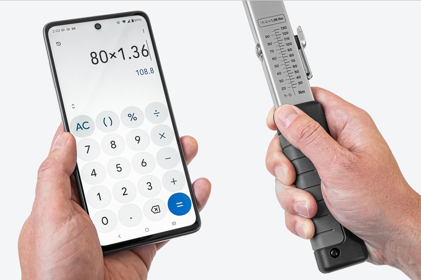 One hand holding a phone with a calculator app, the other holding a torque wrench with the scale visible