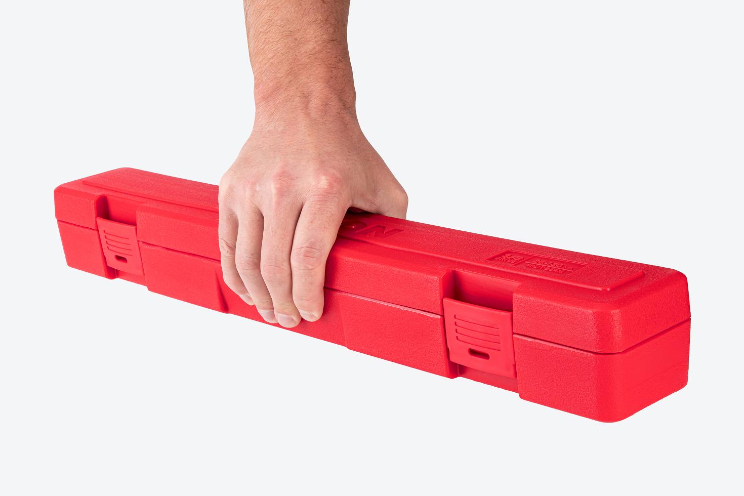 Hand holding a red torque wrench case.