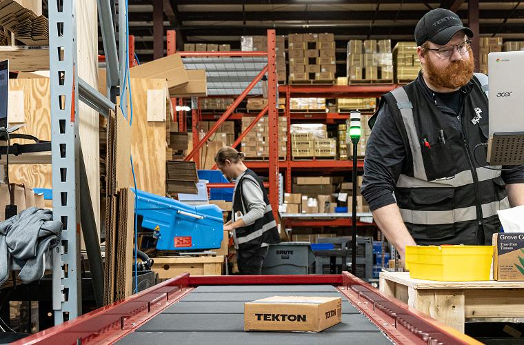A Tekton package on a conveyer in a fulfillment center warehouse