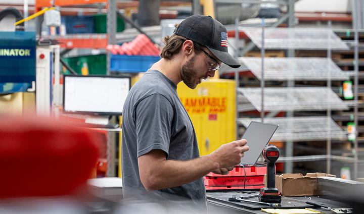 A manufacturing specialist inspecting hand tools in a manufacturing center
