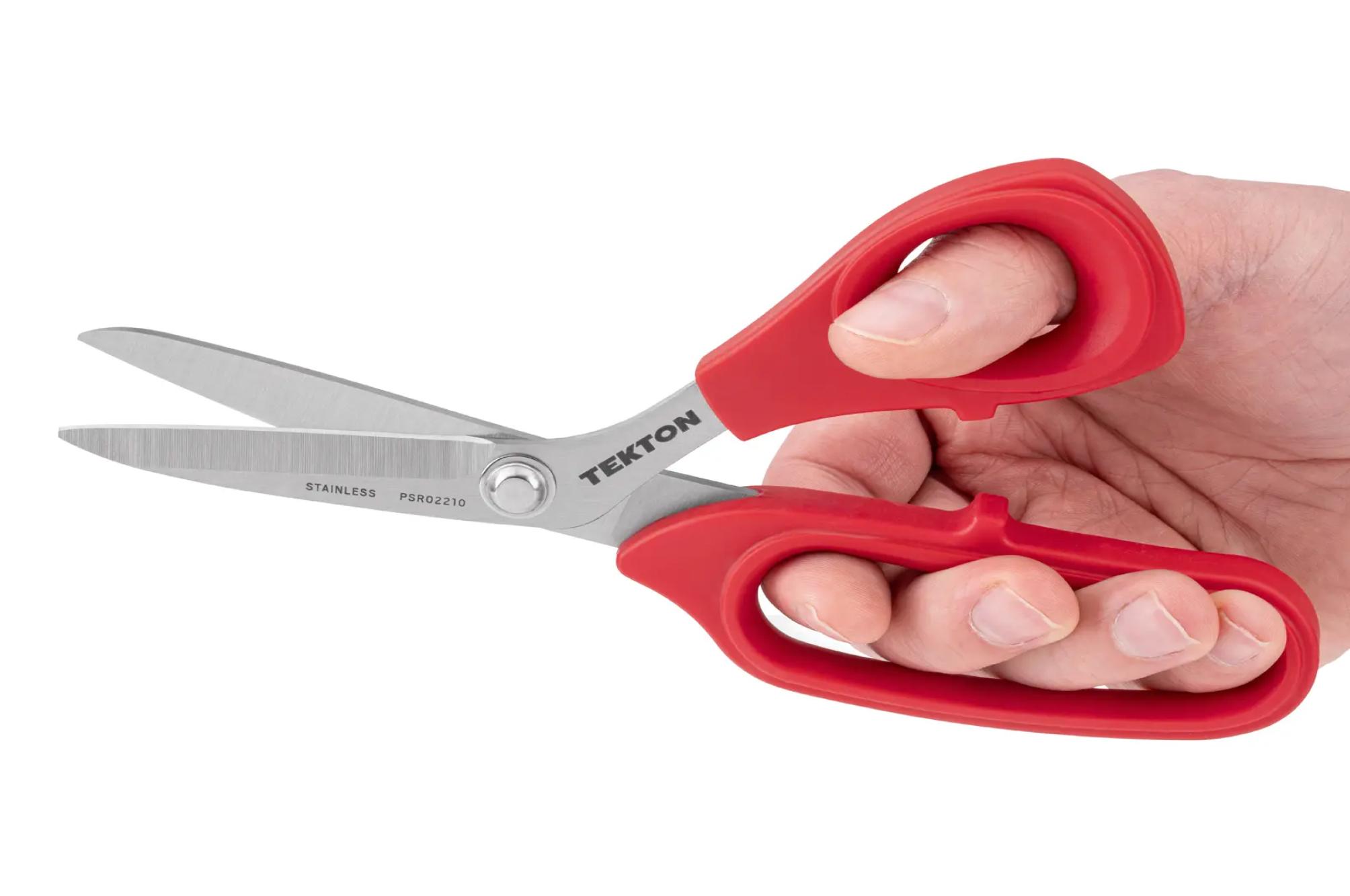 A person holding a Tekton shop scissors