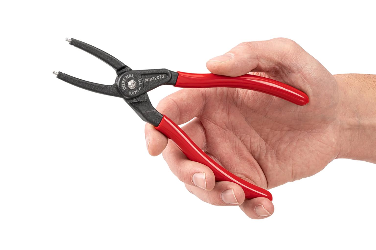 A hand holding retaining ring pliers #PRR22070 on a white background.